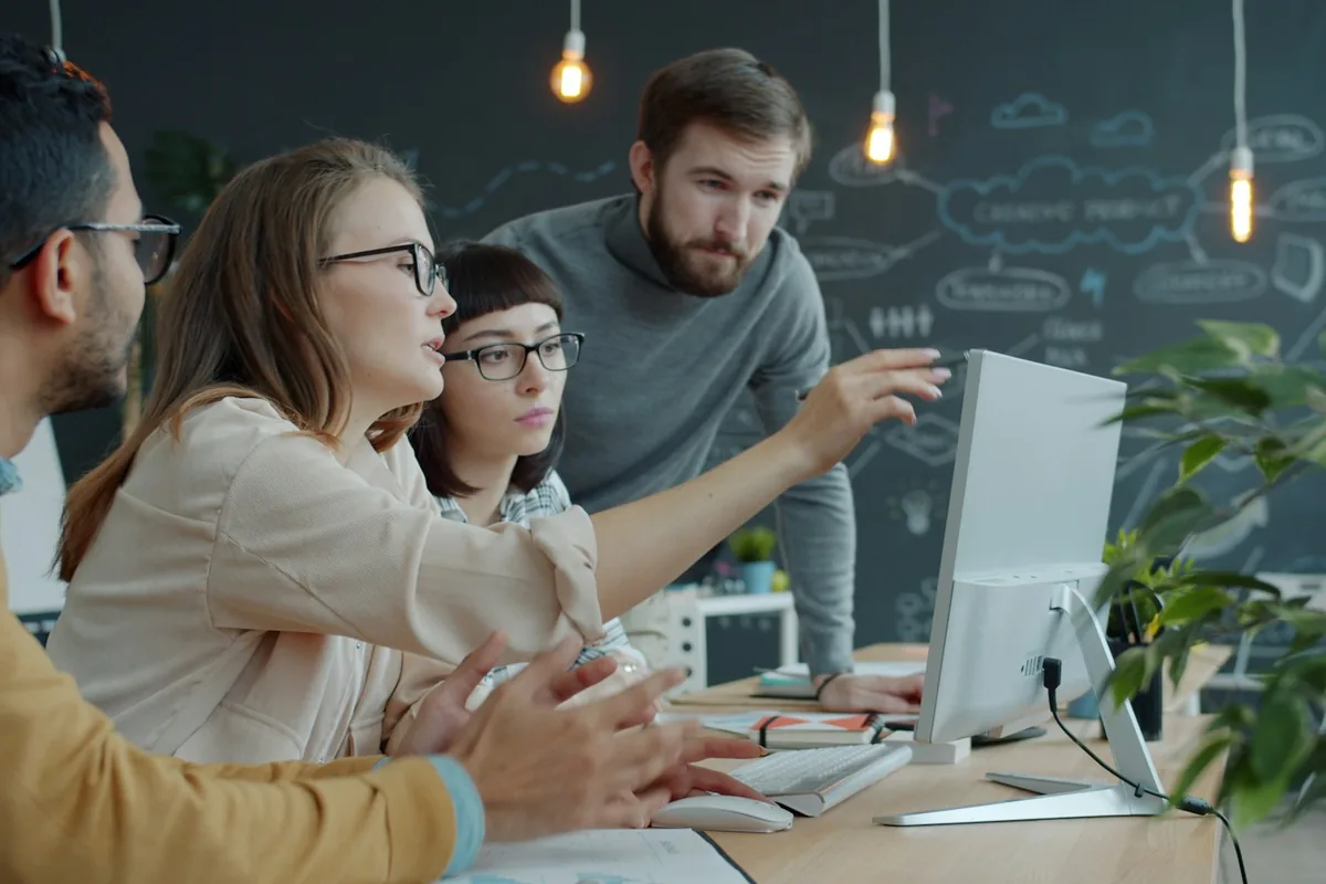 A team of engineers reviewing a design together at a workstation