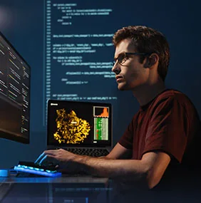 An engineer working through code and monitoring dashboards